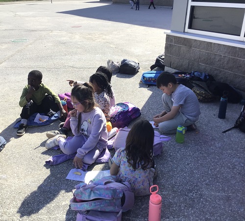 Children eating a "picnic" snack outside.