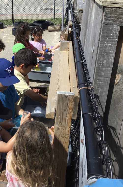 Children demonstrating focus through water play.