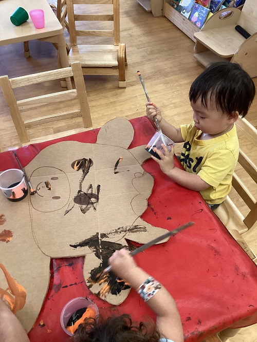 Children painting the cow