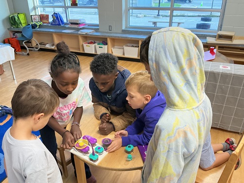 Group of children testing a game out together.