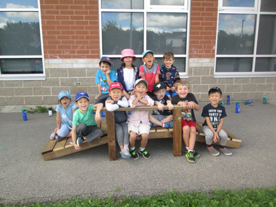 children sitting on the bridge they made