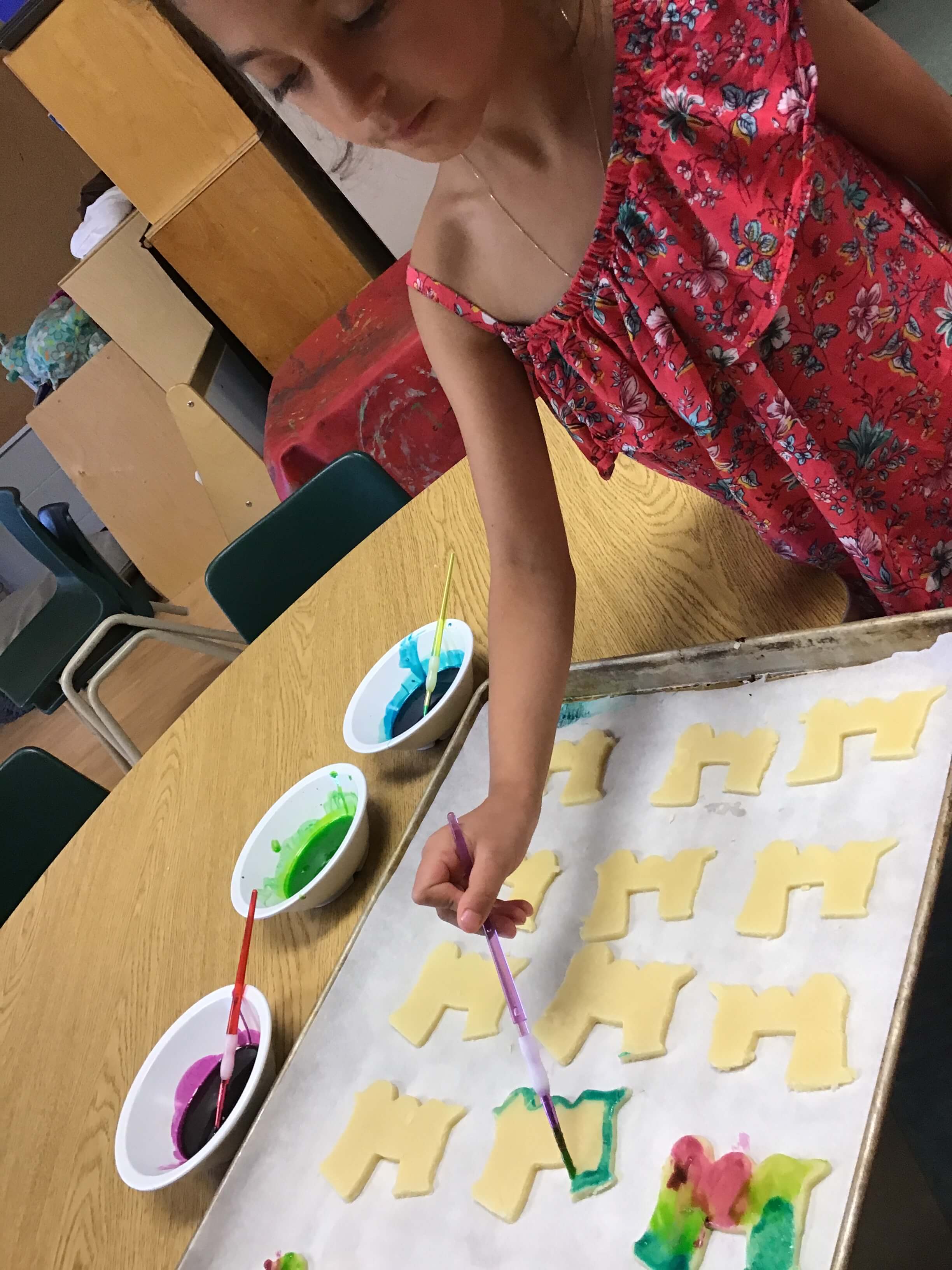 girld painting train cookies