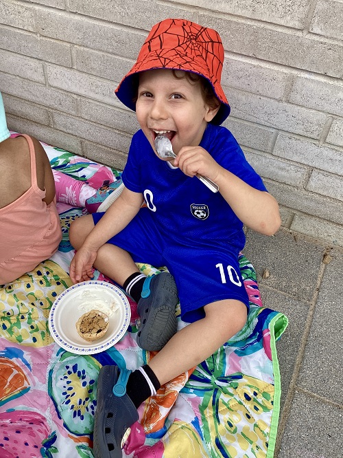 A preschool child eating their pie and ice cream