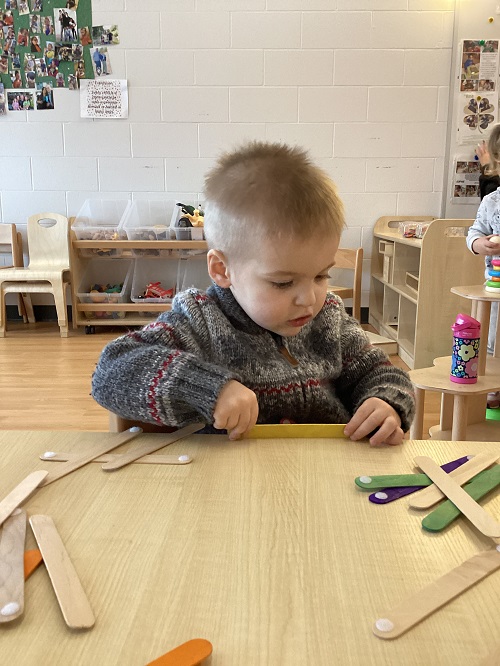 A child exploring with velcro sticks