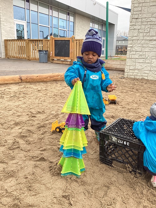 A child stacking star pylons into a pile