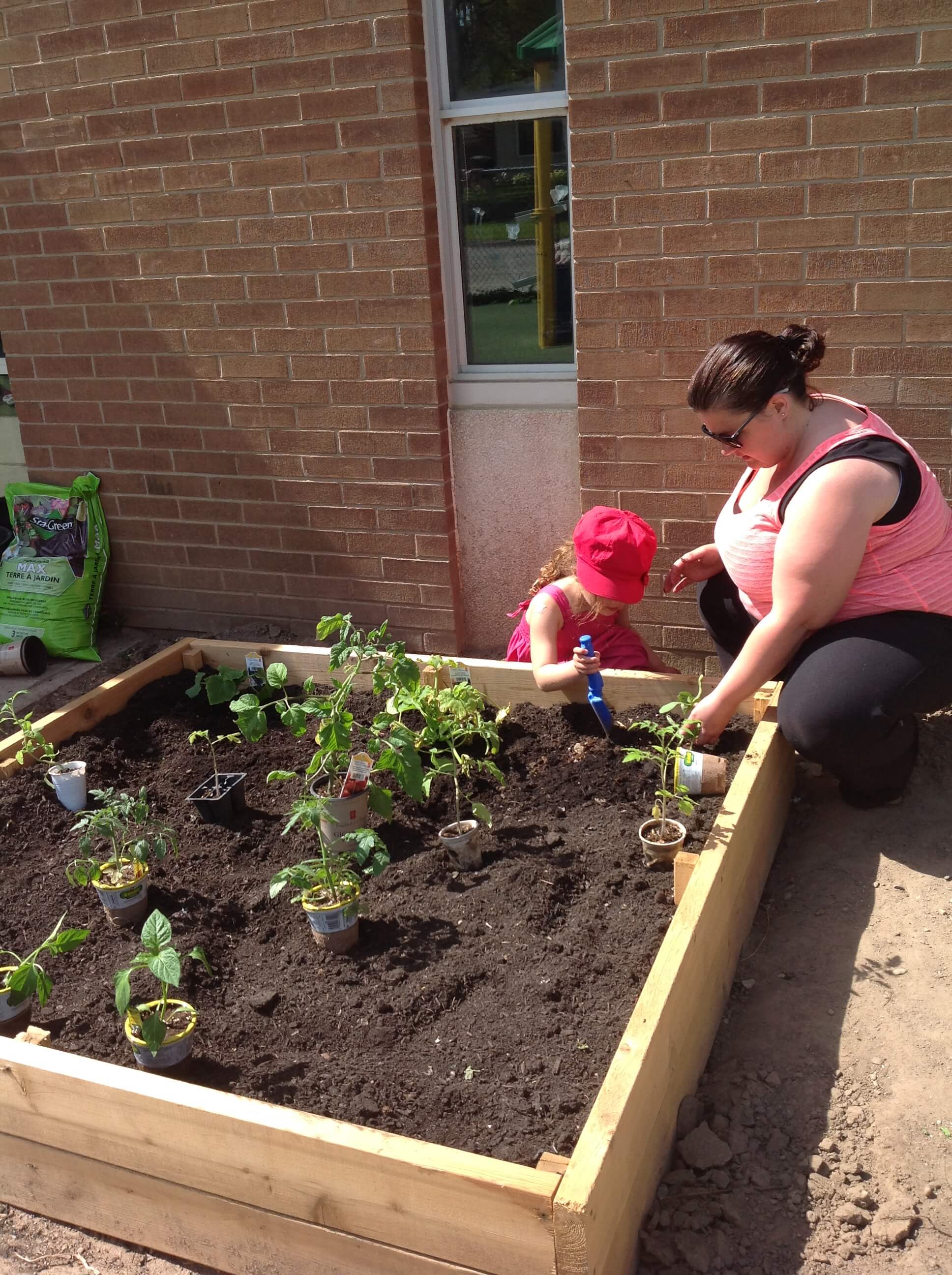 educator and child gardening