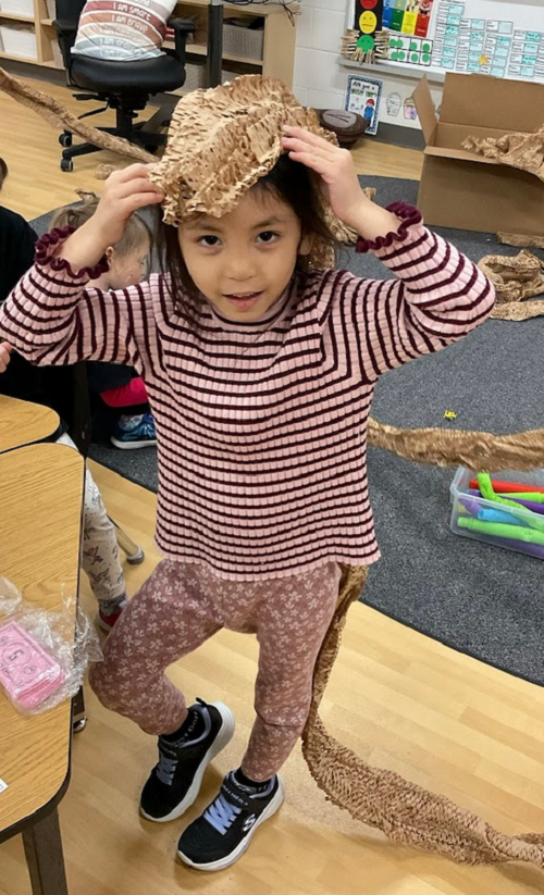 child wearing the materials as a hat