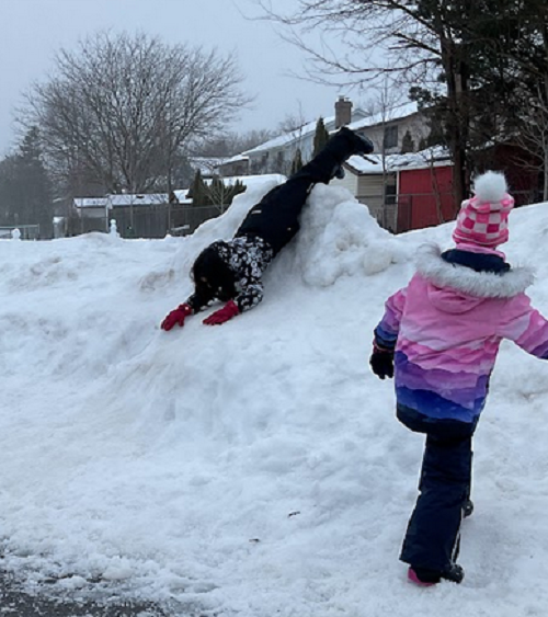 child sliding down hill