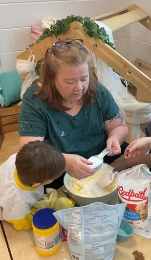 Parent helping the children measure ingredients