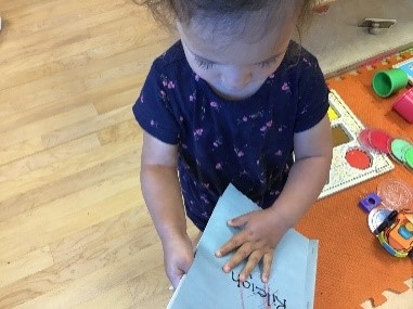 child holding a book
