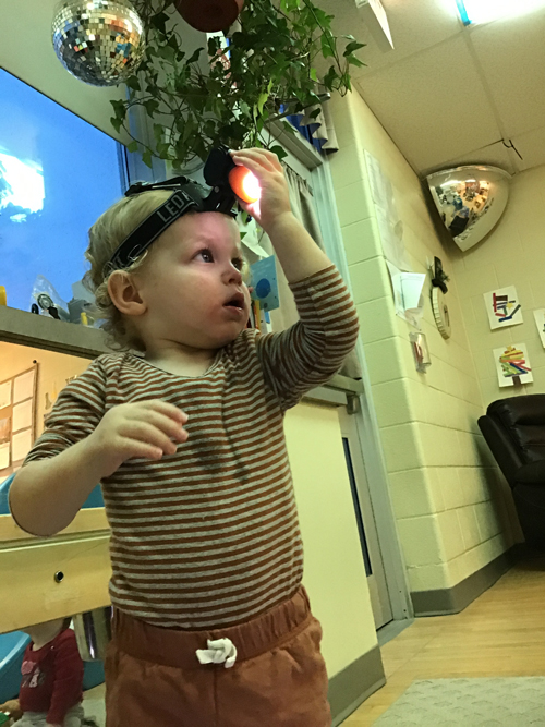 child with head lamp on his head