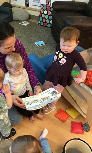Infants listen to an educator read a story