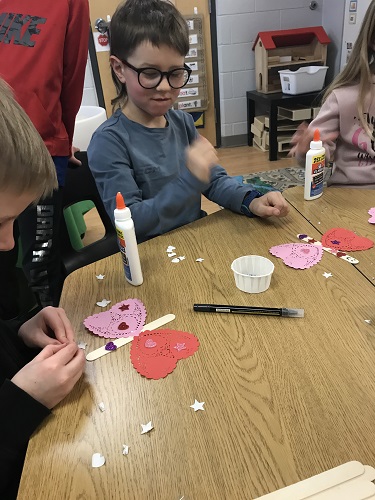 Children creating Valentine's crafts