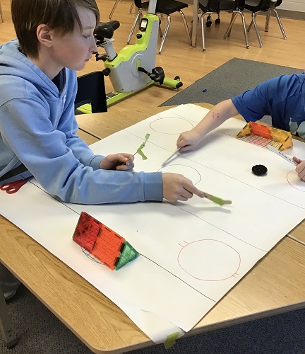 Children playing table hockey